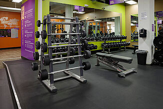 Dumbbell racks and benches at the Anytime Fitness facility, featuring REGUPOL sonusfit m520 flooring.