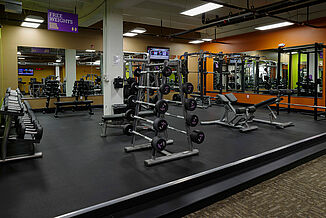 View of the Anytime Fitness facility featuring a dumbbell rack, a weight rack and weighted bars. The facility features REGUPOL sonusfit m520 flooring to provide optimal acoustic insulation.